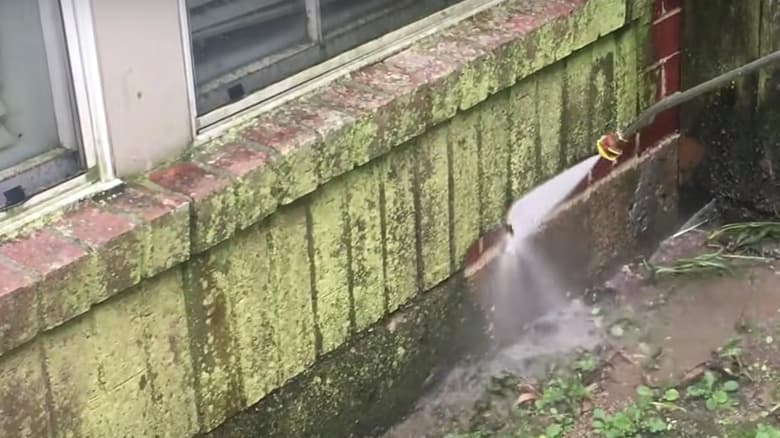 Brickwork being jet-washed clean