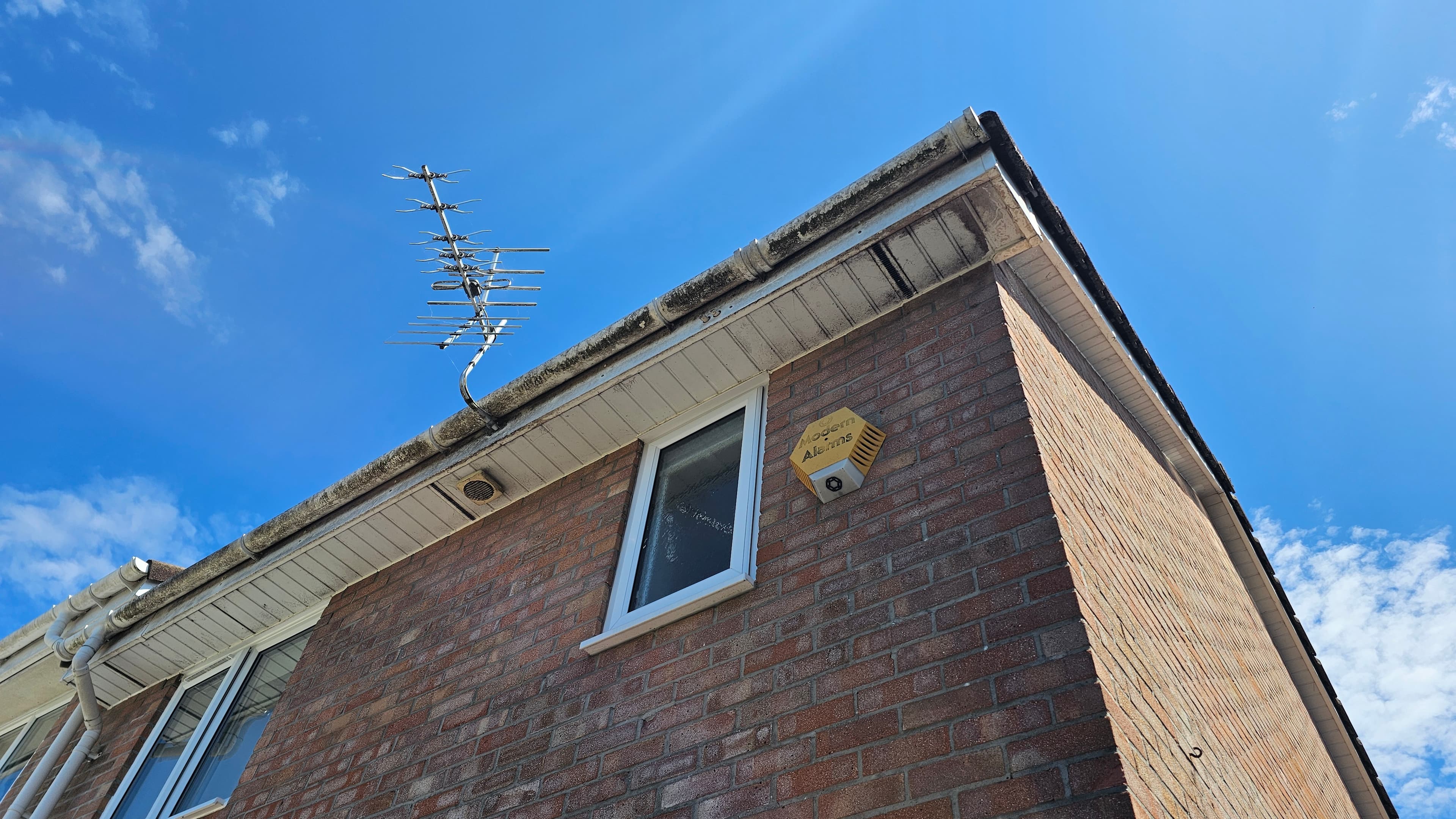 Fascia and soffit being cleaned to bright white